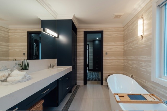 Navy vanity primary bath with freestanding tub